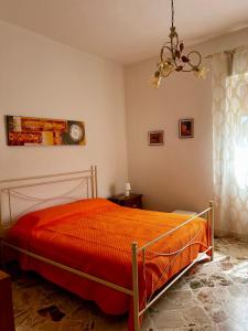 a bedroom with a bed and a chandelier at GRC Apartments Partanna-Mondello in Palermo