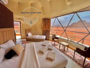 a room with a bed and a view of the desert at Wadi Rum desert camp in Wadi Rum
