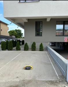 a yellow object in a parking lot in front of a building at Garsoniera Zona Stadion in Craiova