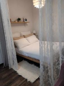a bedroom with a bed with curtains in it at Ancient Gortyna Home -Mitropolis, Heraklion in Mitrópolis