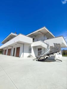a white building with stairs in front of it at Villa Verde in Ceccano