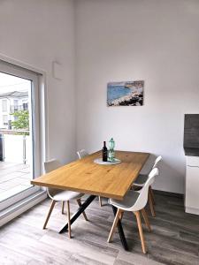 a dining room with a wooden table and chairs at MY HOME AM HEUBERG Nr 6 in Frittlingen