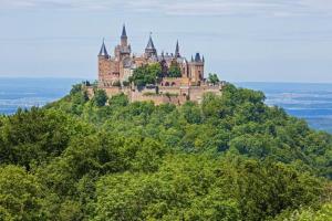 a castle on top of a hill with trees at MY HOME AM HEUBERG Nr 6 in Frittlingen
