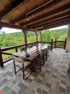 a long wooden table and chairs on a patio at Retreat House Herneacova in Herneacova