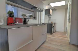 a kitchen with white cabinets and a counter top at T3 2 chambres climatisation au calme 30 mètres du port in La Ciotat