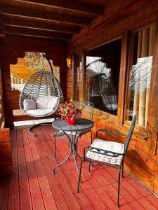 a patio with a table and chairs on a porch at DAJTI PARADISE RESORT in Tirana