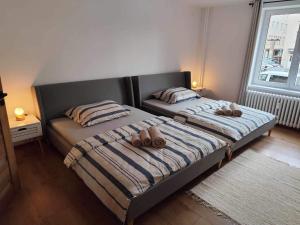 a bedroom with two beds with brown shoes on them at Centrum Poprad Apartment in Poprad