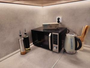 a microwave oven with a box on top of it at Centrum Poprad Apartment in Poprad