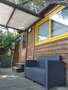 a house with a blue bench on a deck at Villaggio Smeraldo in Moneglia