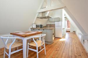 a kitchen with a table and chairs in a room at Le campagne in Arras