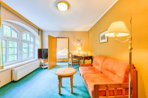 a living room with a couch and a table at Hotel Bodeblick in Thale +27 photos