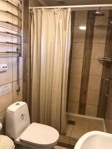 a bathroom with a toilet and a shower at Казковий Світязь in Szack