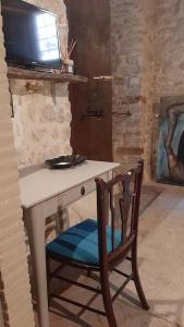 a chair sitting in front of a desk with a television at La chiave del Tempo in Casteldilago +40 photos