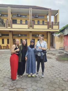 a group of women standing in front of a building at Ratu guest house syariah in Banyuwangi