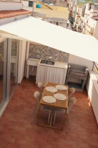 a kitchen with a table and chairs on a balcony at Ciao Appartamenti Centro Paese in Balestrate