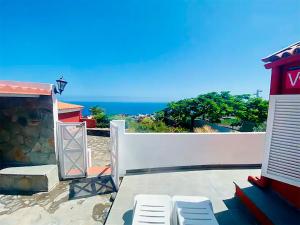 eine Terrasse mit Stühlen und Meerblick im Hintergrund in der Unterkunft Casa El Drago 2 in Breña Baja