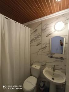 a bathroom with a white toilet and a sink at Zeytindali Apart Hotel in Didim +34 photos