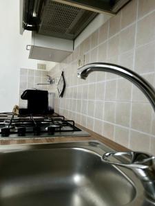 a kitchen with a sink and a stove at GRC Apartments Partanna-Mondello in Palermo