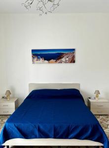 a bedroom with a blue bed and two night stands at GRC Apartments Partanna-Mondello in Palermo