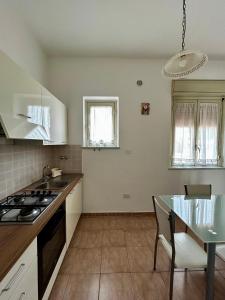a kitchen with a table and a stove top oven at GRC Apartments Partanna-Mondello in Palermo