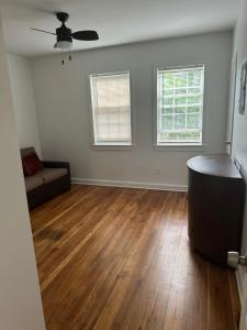 an empty living room with a couch and wood floors at City access in Washington