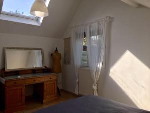 a bedroom with a mirror and a dresser and a window at «  La PETITE MAISON » ....Des grands espaces... in Saint-Maur-des-Fossés