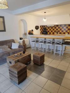 a living room with a couch and a table at L'Alorenlis, duplex vue lac de Sainte Croix in Bauduen