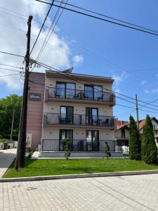 a building with balconies on the side of it at Vila Simfonija in Vrnjačka Banja