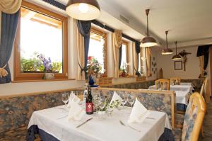 a dining room with two tables in a restaurant at Gasthaus Jaufenblick in San Martino