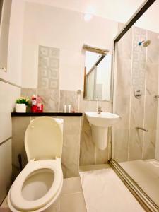 a bathroom with a toilet and a sink at Khalisee homes 1 BDR apartment in Kilifi