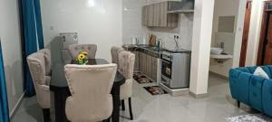 a kitchen with a table and chairs and a stove at Khalisee homes 1 BDR apartment in Kilifi