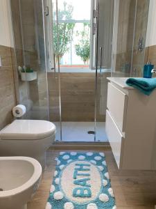 a bathroom with a shower and a toilet and a rug at Enjoy Toscana ! in Livorno +31 photos