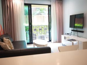 a living room with a couch and a television at Marrakesh Residence 311 in Hua Hin