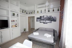a bedroom with a bed and a tv in it at La finestra sul pincio in Civitavecchia