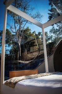 a bedroom with a large window with a bed in it at Hotel Burbuja Zona Esmeralda in Tlazala de Fabela