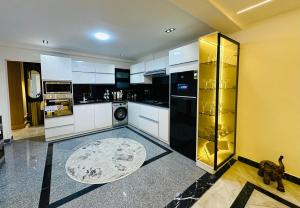 a kitchen with black and white appliances and a rug at Luxury Nile view , Cornish Nile in Cairo