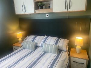 a bedroom with a bed with two pillows on it at 16 Lake View, Pendle View Holiday Park, Clitheroe in Clitheroe
