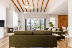 a living room with a couch and a fireplace at Mares - Traiña in Caleta De Velez