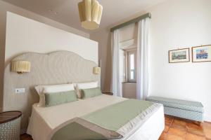 Postel nebo postele na pokoji v ubytování Aqua Mirabilis Relais de Charme
