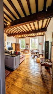 a large living room with a kitchen and a table at Centrally Located Sarlat Apartment with Medieval Town Views in Sarlat-la-Canéda