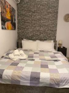 a bedroom with a large bed with a brick wall at Central & Riverfront Room in Edessa