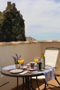 Una mesa con dos vasos de jugo de naranja en un patio. en Hospedium DLJ Enjoy Cazorla apartamentos, en La Iruela