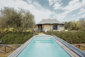 a house with a swimming pool in front of a house at E-glamping/Blue Saphir Tent in Arezzo