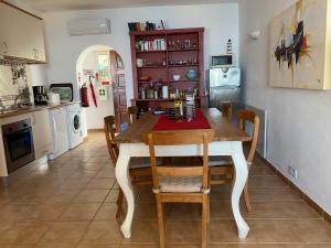 a kitchen and dining room with a table and chairs at Ocean View in Carvoeiro
