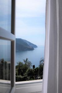 a view of the ocean from a window at My Place Your Place in Corniglia