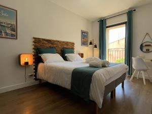 a bedroom with a large bed and a window at Les Gîtes de Monte Blanco - Chambres d'hôtes et gîtes in Montblanc +31 photos