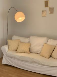 a white couch with pillows in a living room at Ferienwohnung Zumhof in Rudersberg