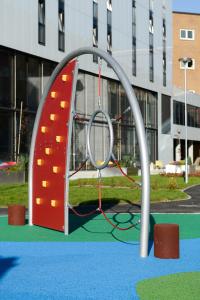 a playground with a climbing frame in a building at Pingvinhotellet UNN Tromsø in Tromsø