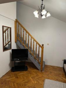 a living room with a staircase with a flat screen tv at Apartments Cunski in Čunski