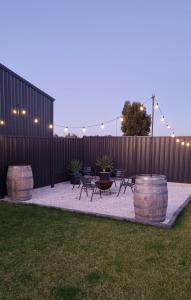 a patio with tables and chairs and a fence at Wellington marina70 in Wellington East